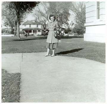 Olive standing on sidewalk