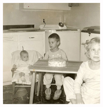 children celebrating birthday in kitchen