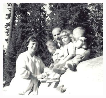 Olive and Jay with kids sitting on a log