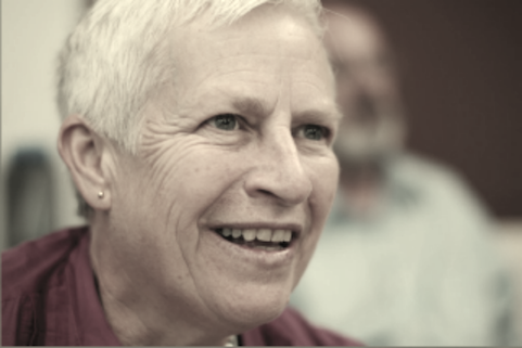 close up of Cindy Selfe's face, smiling and looking off-camera