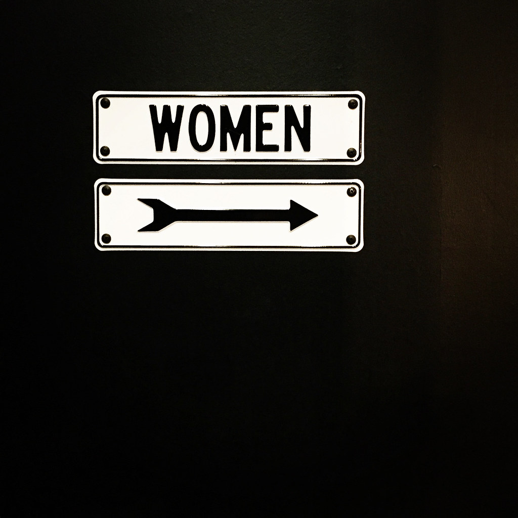 women sign with arrow pointing right