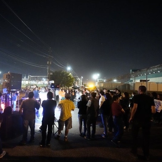 Los Jornaleros Del Norte performing at a large gathering of protestors in the parking lot of the Essex County Detention Center.