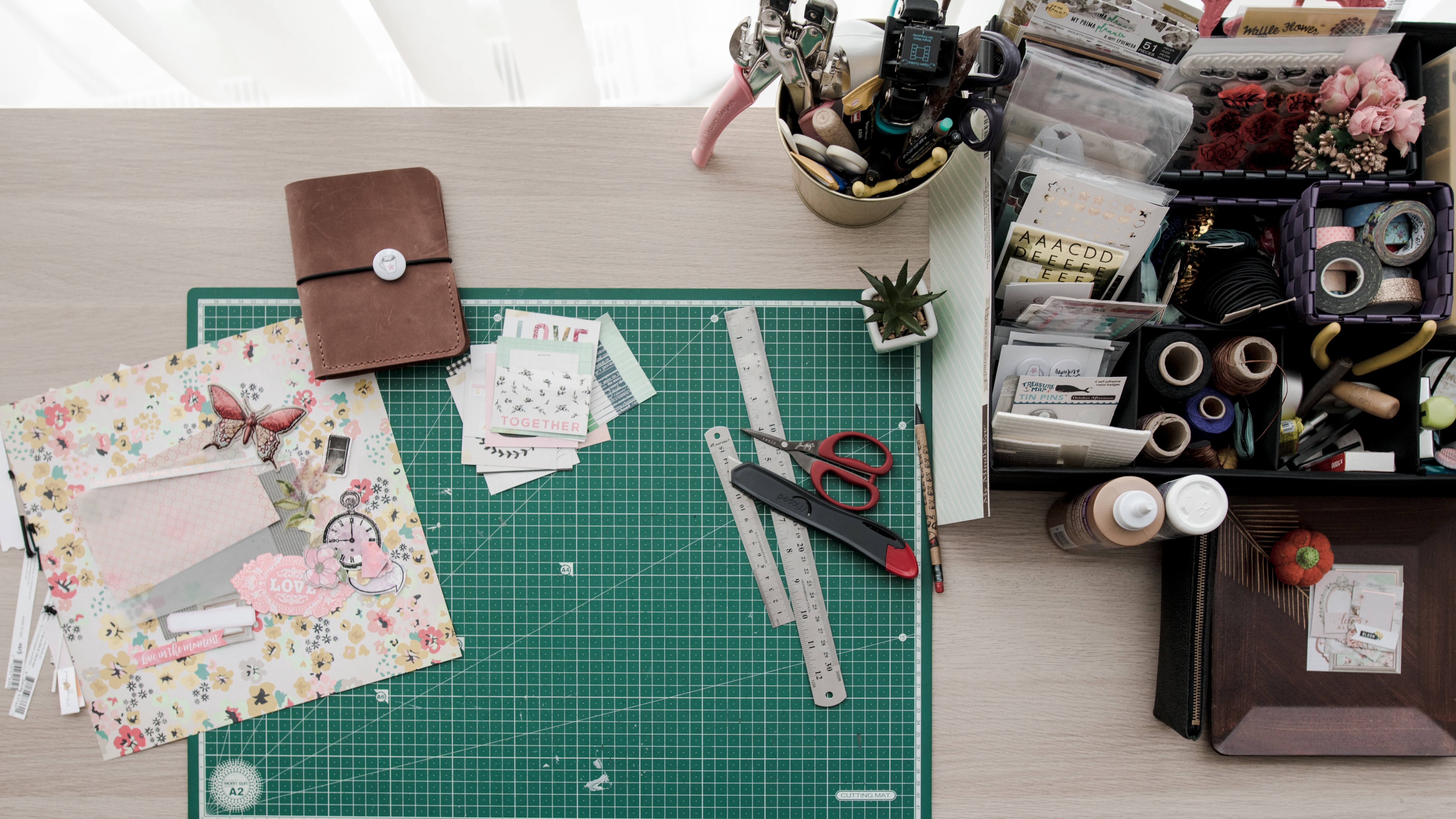 A green cutting mat with craft paper and scissors