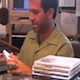 David Sommerstein, a white man at desk with microphone and music CDs