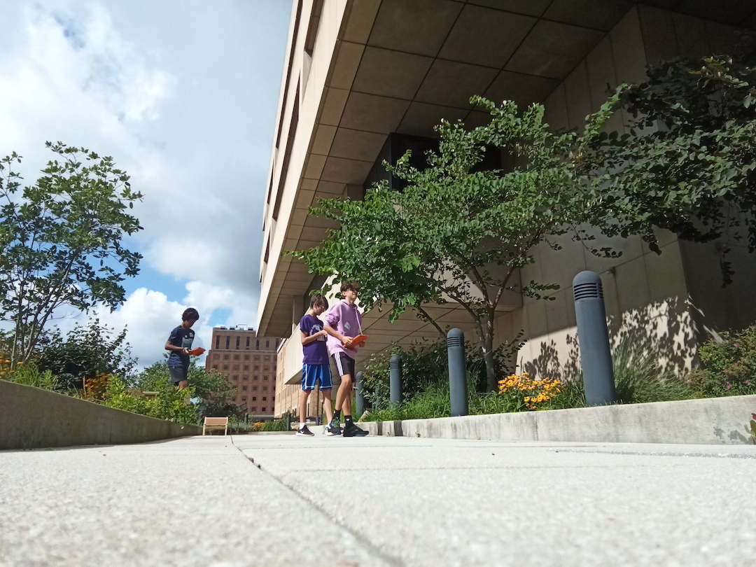 Students in the distance, photographing the rooftop garden.